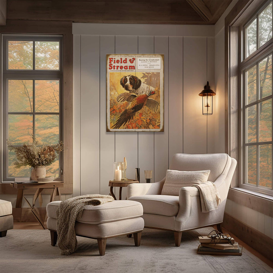 Cozy living room with a white armchair, ottoman, and 'Field & Stream' poster on the wall.