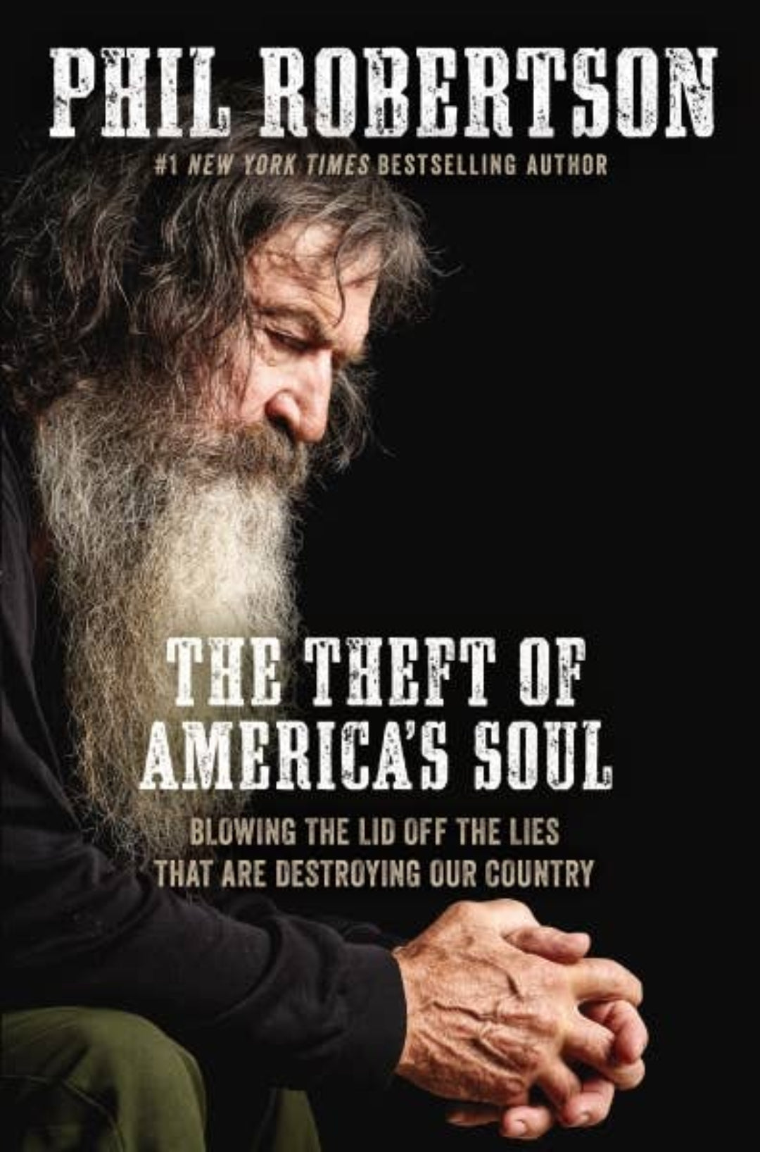 Book cover of 'The Theft of America's Soul' by Phil Robertson with a black background