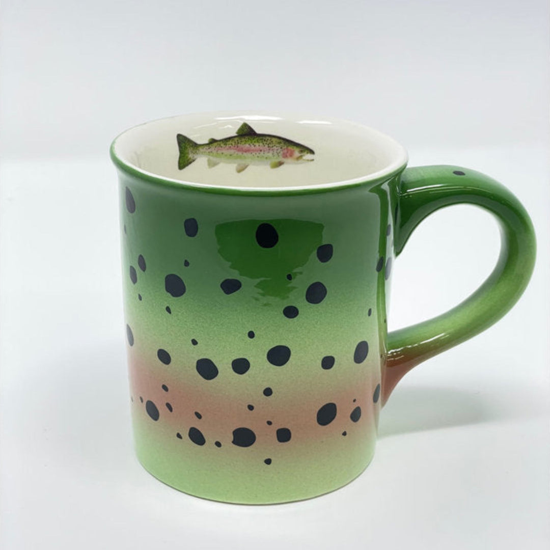 Green mug with fish design on a white background