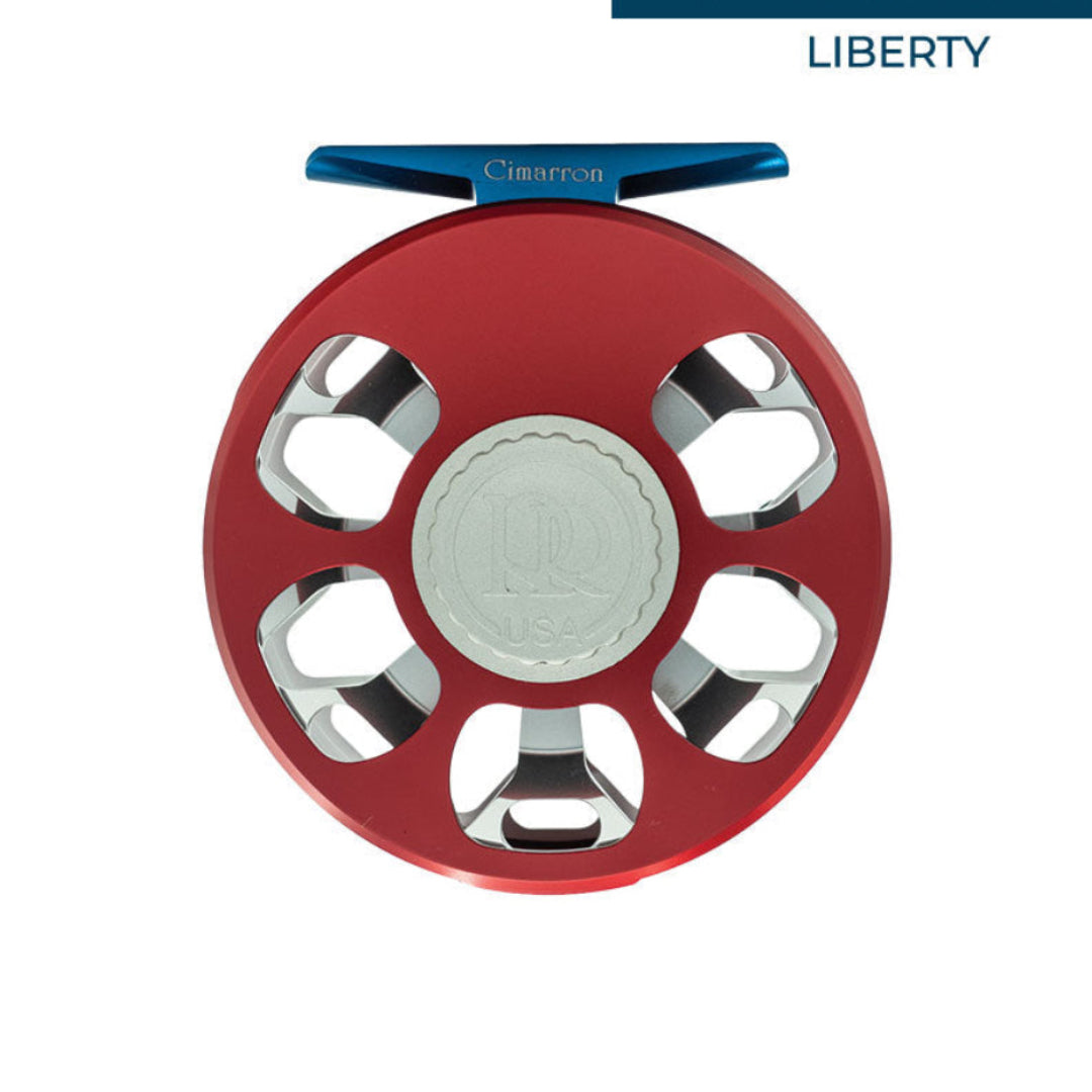 A red and blue fly fishing reel shown from a top-down view on a white background, with the brand name 'Liberty' visible in the top right corner.