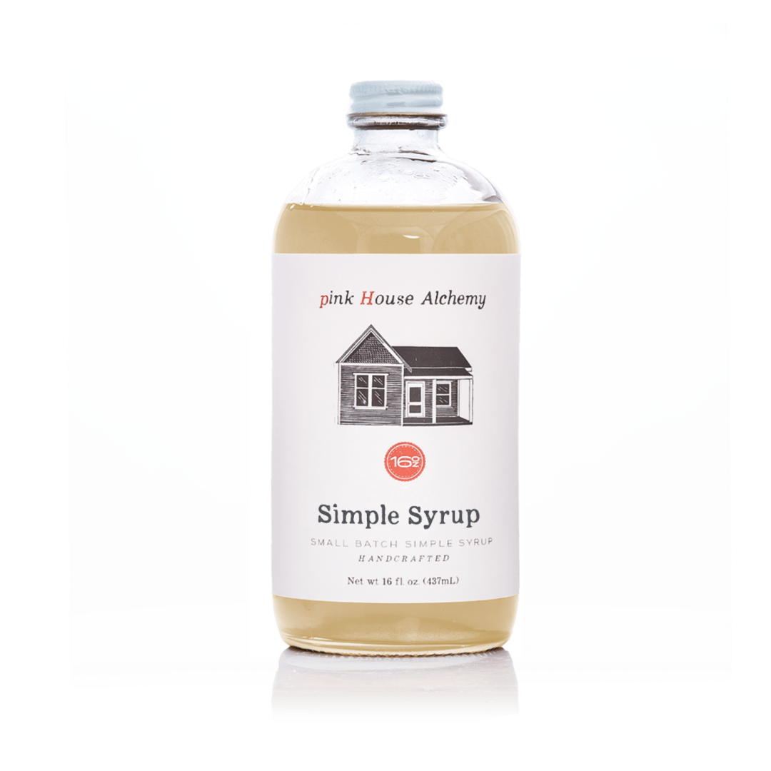 Bottle of pink House Alchemy simple syrup on a white background