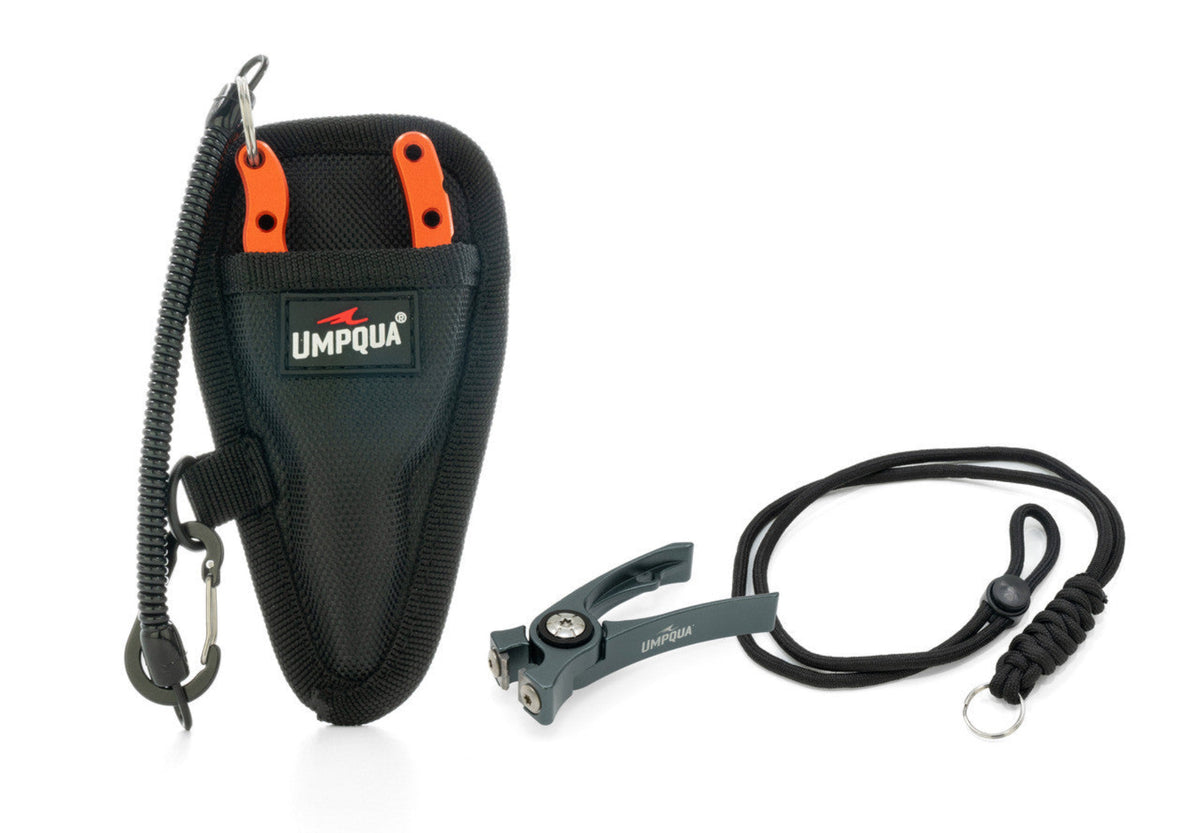 Umpqua fishing reel with black and orange handle on a white background