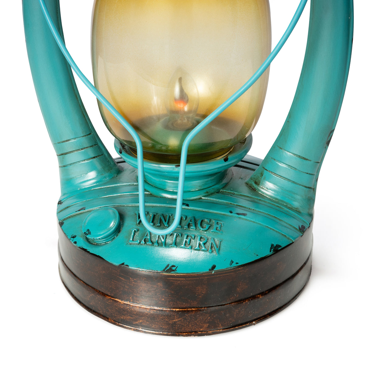 Close-up of a vintage-style lantern with a turquoise painted metal body, a warm amber-tinted glass chamber, and a dark brown distressed base. The words 'VINTAGE LANTERN' are embossed on the front.