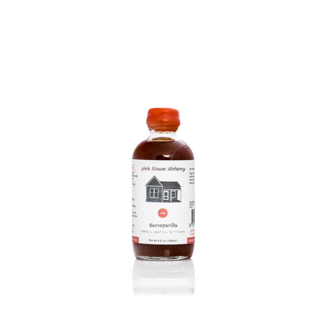 Bottle of pink house alchemy balsamirin on a white background