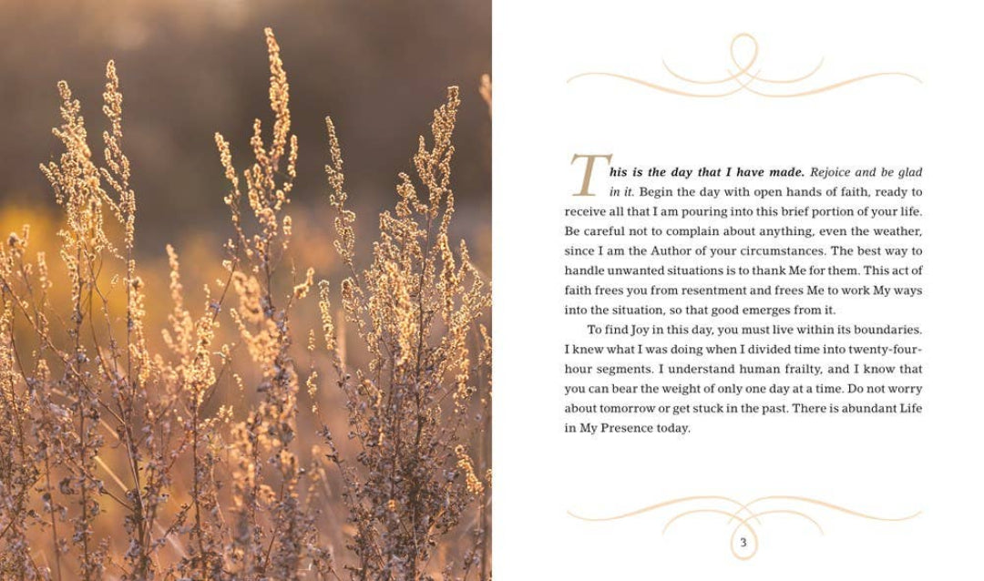 An open book spread showing a nature photograph of wild grasses on one page and a printed devotional text passage with a large letter T on the other page.